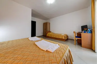 a bedroom with a bed with two towels on it at Garni Hotel S Coast in Budva