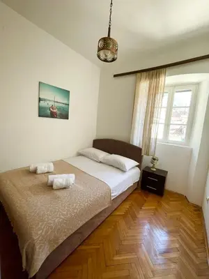 a bedroom with a bed with two towels on it at Old Town Heart in Kotor