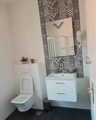 a bathroom with a toilet and a sink and a mirror at Old Town Heart in Kotor