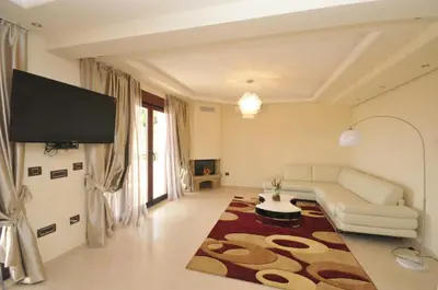 a living room with a couch and a flat screen tv at St.George Apartments in Petrovac na Moru