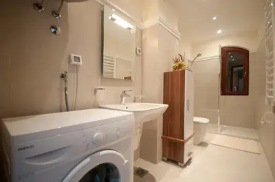 a bathroom with a washing machine and a sink at St.George Apartments in Petrovac na Moru