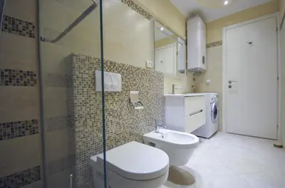 a bathroom with a toilet and a glass shower at St.George Apartments in Petrovac na Moru