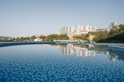 a large pool of water with buildings in the background at Status-M Apartments 174 in Becici