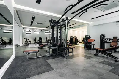 a gym with a bunch of equipment in a room at Status-M Apartments 174 in Becici
