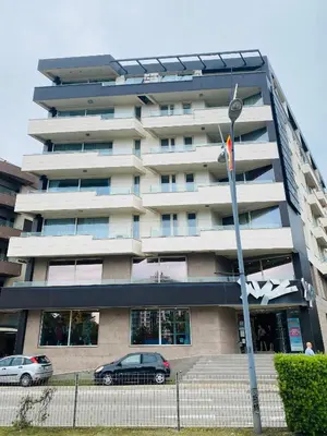 a building with two cars parked in front of it at Lux Panorama in Budva
