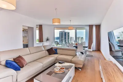 a living room with a couch and a table at Lux Panorama in Budva