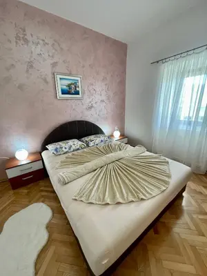 a bedroom with a large bed in a room at Apartments Marina in Becici