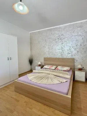 a bedroom with a large bed with purple sheets at Apartments Marina in Becici