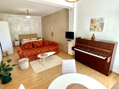 a living room with a couch and a piano at Apartments Marina in Becici