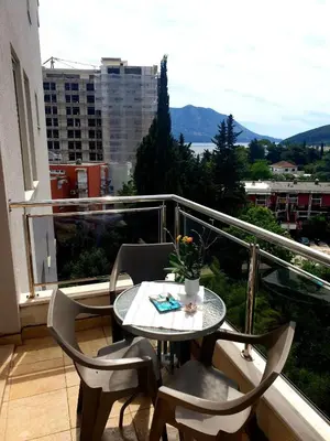 a table and chairs on a balcony with a view at City & Sea Apartment nearby Old Town in Budva