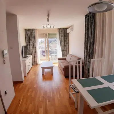 a living room with a couch and a table at City & Sea Apartment nearby Old Town in Budva