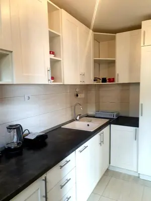 a kitchen with white cabinets and a sink at City & Sea Apartment nearby Old Town in Budva
