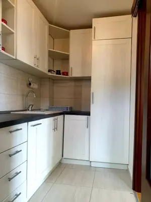 a kitchen with white cabinets and a sink at City & Sea Apartment nearby Old Town in Budva