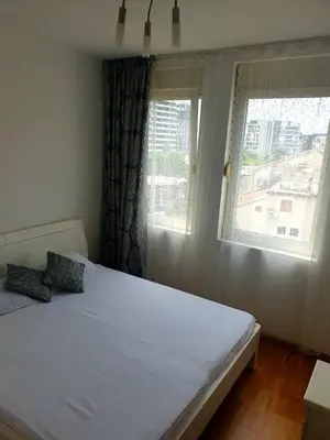 a bedroom with a white bed and a window at City & Sea Apartment nearby Old Town in Budva