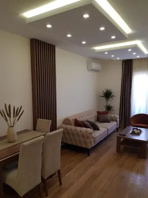 a living room with a couch and a table at Apartman VIVO city central in Podgorica