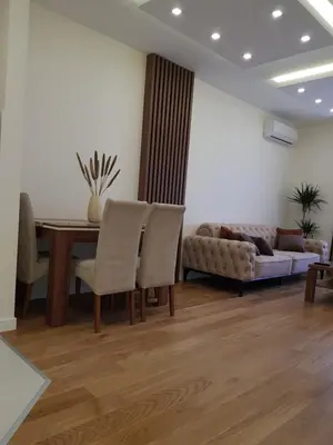 a living room with a couch and a table and chairs at Apartman VIVO city central in Podgorica