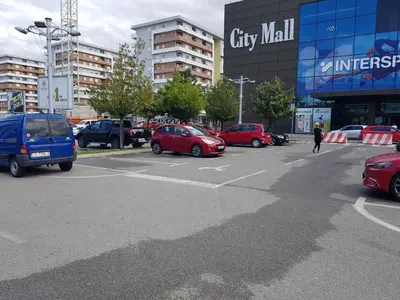 a parking lot full of cars in a city at Apartman VIVO city central in Podgorica