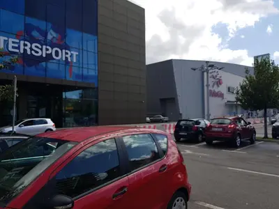 a red car parked in front of a building at Apartman VIVO city central in Podgorica