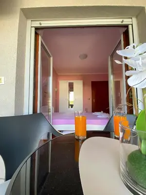 a table with two glasses of orange juice on it at Apartment Center Adria in Bar