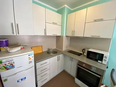 a small kitchen with white cabinets and a sink at Apartment Center Adria in Bar