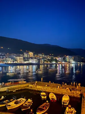 a group of boats docked in a harbor at night at Apartment Center Adria in Bar