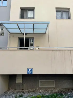 a building with a balcony with a sign on it at Ada apartman in Budva