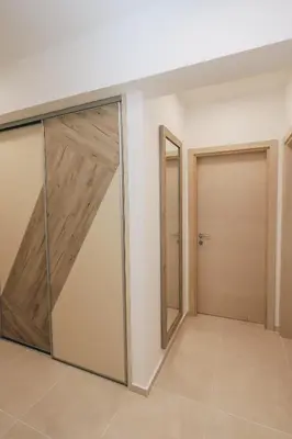 a room with sliding doors in a house at Status-M Аpartments 173 in Becici