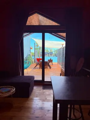 a living room with a view of a deck at Ada Bojana Beach House I XXL TerraceI BBQ I Betw BridgeBeach I Air Con in Ulcinj