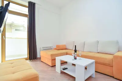 a living room with a couch and a table at Victoria Center Apartments in Budva