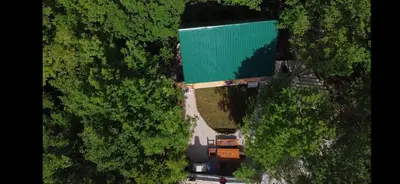 an overhead view of a green building in a forest at Brvnara Fairy Tale in Cetinje