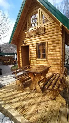 a log cabin with a picnic table on a deck at Brvnara Fairy Tale in Cetinje