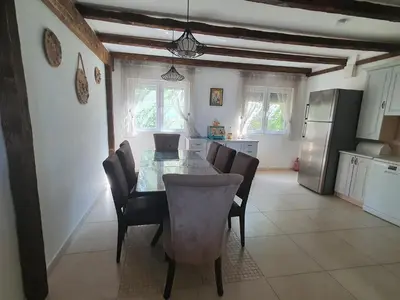 a kitchen and dining room with a table and chairs at Peaceful Sea Residence in Bigovo