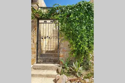 an entrance to a stone building with a metal gate at Peaceful Sea Residence in Bigovo