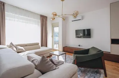 a living room with two couches and a tv at Status-M Apartments 179 in Becici