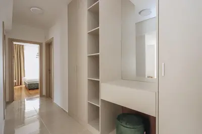 a room with white walls and a glass cabinet at Status-M Apartments 179 in Becici