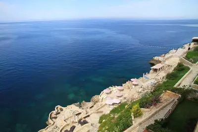 an aerial view of the ocean and a stone wall at Bella Costa in Dobra Voda