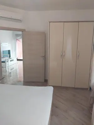 a room with white cabinets and a bed in it at Bella Costa in Dobra Voda