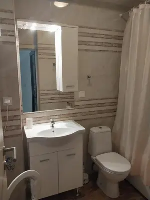 a bathroom with a sink and a toilet and a mirror at Bella Costa in Dobra Voda