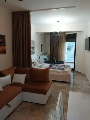 a living room with a couch and a bed at Bella Costa in Dobra Voda