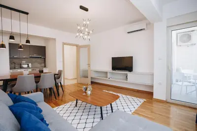 a living room with a couch and a table at Status-M Apartments 205 in Becici