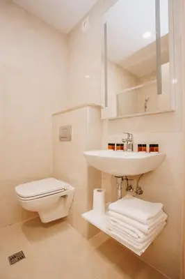 a white bathroom with a sink and a toilet at Status-M Apartments 205 in Becici