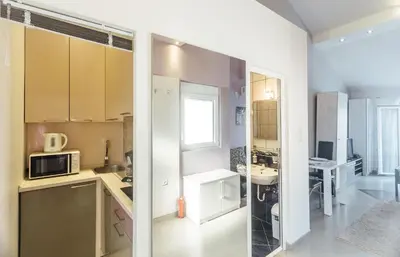 a kitchen with a sink and a microwave at Beachfront Apartments Tivat in Tivat