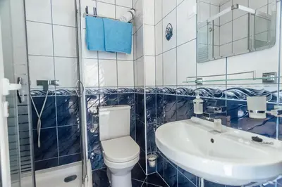 a bathroom with a toilet and a sink at Beachfront Apartments Tivat in Tivat