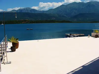 a view of a lake with mountains in the background at Beachfront Apartments Tivat in Tivat
