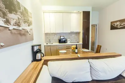 a kitchen with a wooden counter top in a room at Beachfront Apartments Tivat in Tivat