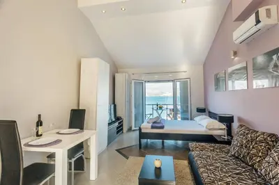 a living room with a bed and a couch at Beachfront Apartments Tivat in Tivat