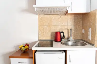 a kitchen with a sink and a red appliance at Apartments Sejla in Ulcinj