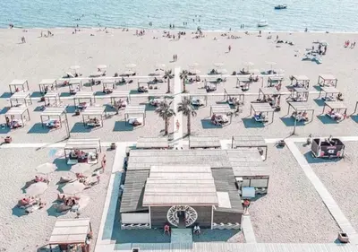an overhead view of a beach with umbrellas and people at Apartments Sejla in Ulcinj