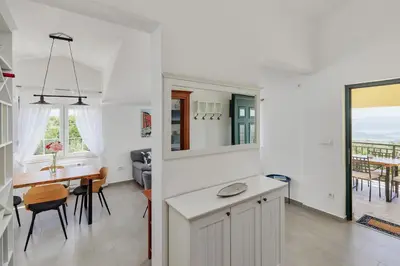 a kitchen and dining room with a table and chairs at Villa Forest & Blue in Kotor