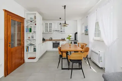 a kitchen and dining room with a table and chairs at Villa Forest & Blue in Kotor